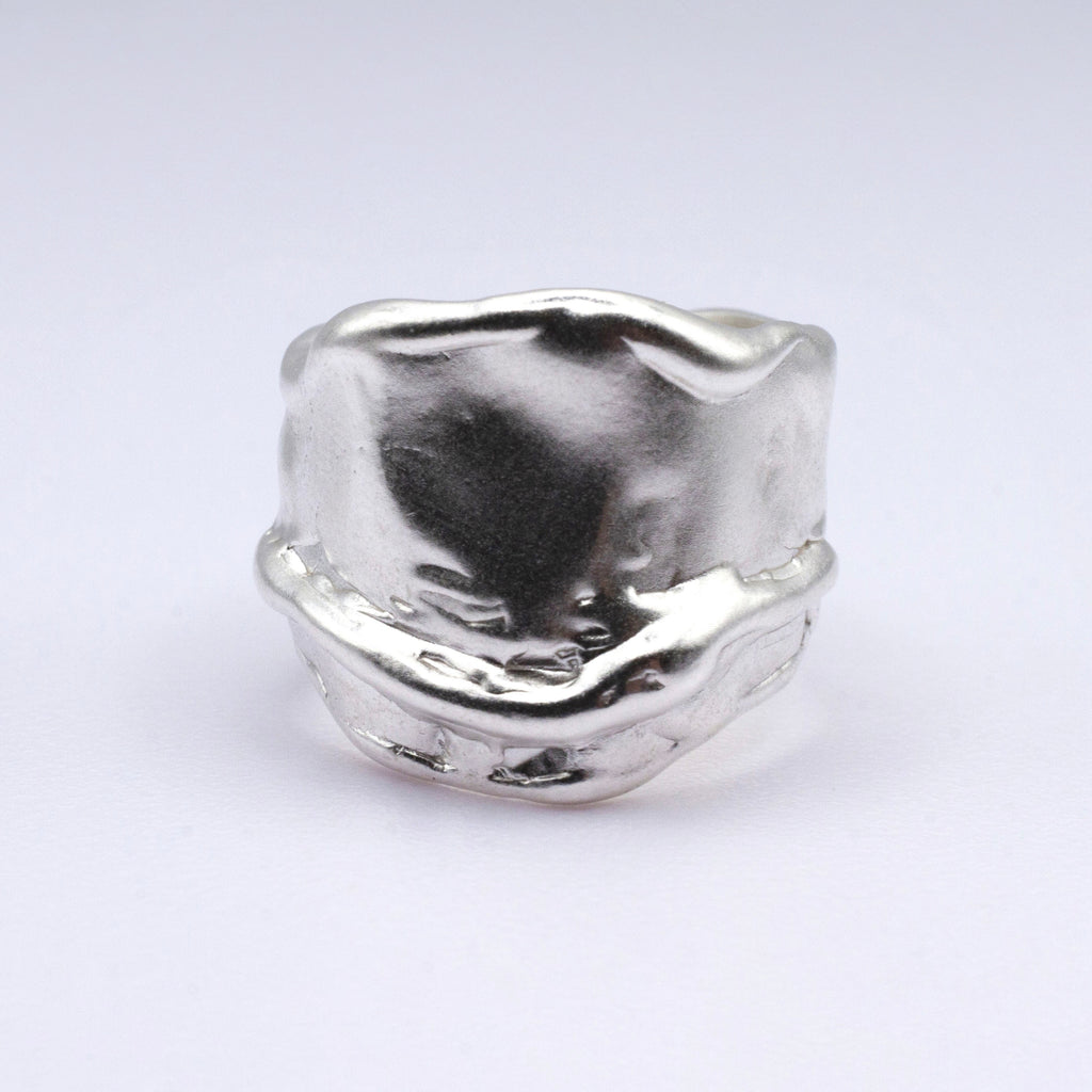 Silver ring with a unique design on a white background