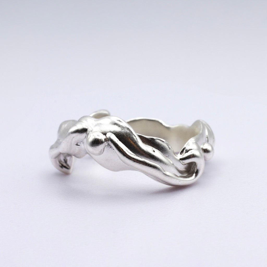 Silver ring with a unique design on a white background