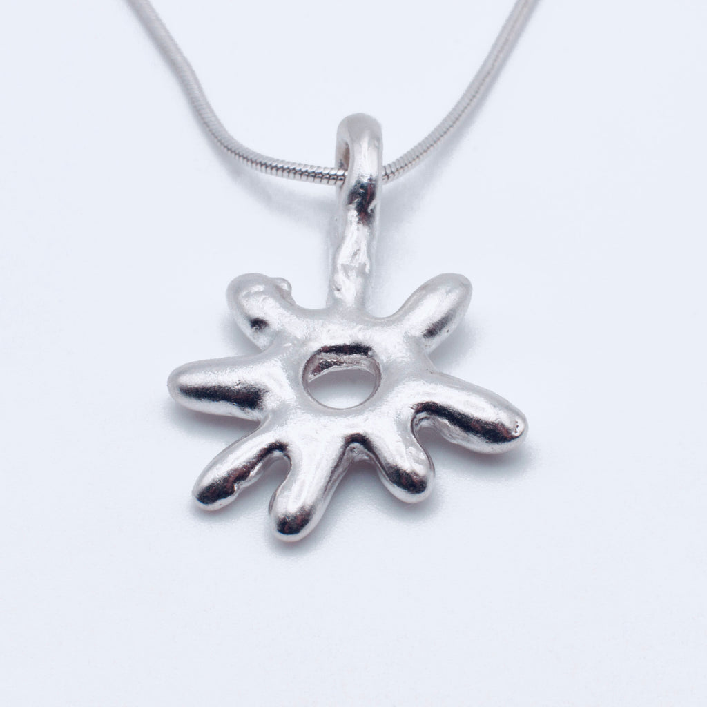 Silver star pendant on a white background