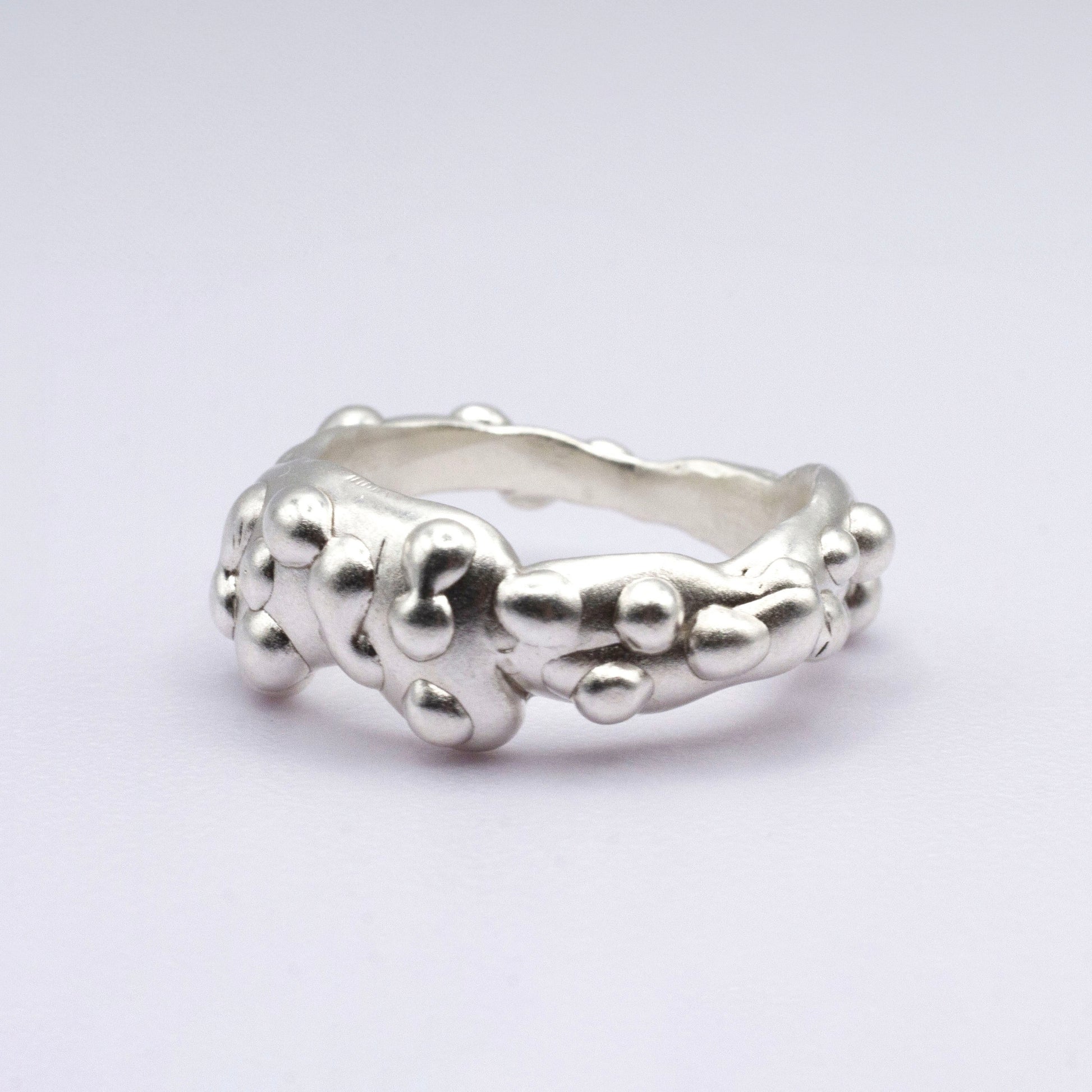 Silver ring on a light gray background